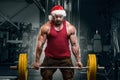 Bodybuilder in Santa Claus costume in gym