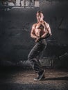 Bodybuilder posing over grunge wall Royalty Free Stock Photo