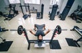 Bodybuilder trainer man doing bench press workout in gym. Photo from the top. Strong abs. Health life sport concept. Royalty Free Stock Photo