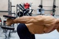 Male athlete doing deltoid exercise with dumbbells