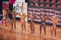 Bodybuilders showing their double biceps pose in a lineup compar Royalty Free Stock Photo