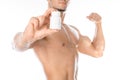 Bodybuilding and chemical additives: handsome strong bodybuilder holding a white jar of pills on white isolated background in stud