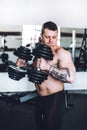 Bodybuilding coach on strength training in the fitness room