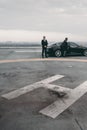 bodyguard and businessman standing near car