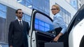 Bodyguard in suit opening car door to female boss, luxury service, success Royalty Free Stock Photo