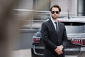 bodyguard in sunglasses and suit standing Royalty Free Stock Photo