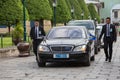 Bodyguards protect state automobile, which moves in the Grand Palace in Bangkok. Thailand