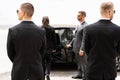 Bodyguards Protecting Businesswoman Opening Car Door Royalty Free Stock Photo