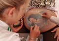 Bodypaint on a pregnant woman's belly