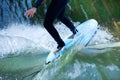 Bodypart of a surfer surfing on the flowings water Royalty Free Stock Photo