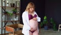 Bodypositive. pregnant woman with overweight in underwear stroking belly.