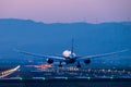 Boeing airplane landing at dusk