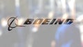 Boeing Company logo on a glass against blurred crowd on the steet. Editorial 3D rendering