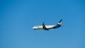 Boeing 737-900ER descends for landing at Adler airport runway against blue spring sky. Boeing 737-900ER VQ-BYO Azur Air.