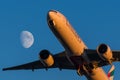 Boeing 777-300er Emirates Airlines takes off on a background of the moon