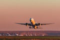 Boeing 777-300er Emirates Airlines takes off at sunset