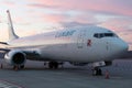 Boeing 737-800 from Luxair parked on an airport ramp at sunset