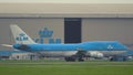 Boeing 747-406-M- of KLM airlines rides past the hangar of KLM Royalty Free Stock Photo