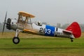 A Boeing Stearman biplane coming in for a landing