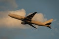 Boeing 777-200 taking off at dusk