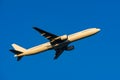 Boeing 777-300 taking off at dusk