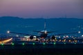 Boeing 777-200 taking off at dusk