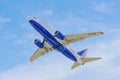 Boeing 737 of Transaero Airlines, with tail number EI-EUZ against the blue sky with light clouds. Flight of a jet plane Royalty Free Stock Photo