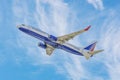 Boeing 737 of Transaero Airlines, with tail number EI-UNK against the blue sky with light clouds. Flight of a jet plane Royalty Free Stock Photo