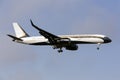 Boeing 757 with vapor trails.