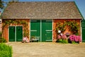 An old refurbished farm barn surrounded by Hydrangeas.