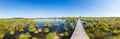 Bog landscape with wooden trail over a lake panorama Royalty Free Stock Photo