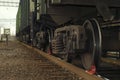 A bogie of freight railcar closeup, with brake shoe