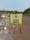 Bogor, Indonesia-February 4 2022: sign board that reads be careful because there is project work