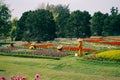 Bogor, Indonesia - Female asian workers in hijab, a traditional hat and orange uniforms gardening and taking care of the colorful