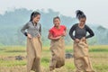 Playing sack race in dry rice fields