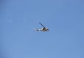 Yellow and green army helicopter flying with blue sky at background