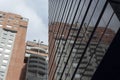 BOGOTA, COLOMBIA Low angle view of an old brick building reflected in a modern skyscraper windows Royalty Free Stock Photo