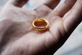 Close up to a male hand holding a replica of the lord of the rings ring of power