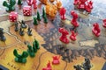 close up to a Risk strategy board game with red dice and paws of LOTR trilogy edition