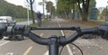 Firts person view of a mountain bike handle bar with bicycle lane at background at bogota colombia city