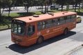 An orange SITP bus transiting at north highway during bogota no car day event