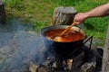 Bograch. Soup with paprika, meat, bean, vegetable, dumpling. Traditional Hungarian Goulash in cauldron. Meal cooked outdoors on an Royalty Free Stock Photo