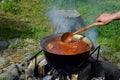 Bograch. Soup with paprika, meat, bean, vegetable, dumpling. Traditional Hungarian Goulash in cauldron. Meal cooked outdoors on an Royalty Free Stock Photo