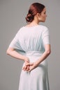 Bohemian bridesmaid dress with flutter sleeves. Effortless summer look. Ginger lady in elegant evening gown. Bun hair style