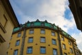 A bohemian building with a yellow wall and a green roof Prague, Czech Republic