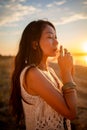 Bohemian chic gypsy happy free asian woman with manicure wearing hands jewelry accessories and white dress. Royalty Free Stock Photo