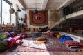 A bohemian living room bursting with furniture, rugs, and floor cushions in a colorful array, Bohemian living room with floor