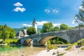 Bohinj bridge and church, Slovenia. Look to old historic ancient bridge and the church near the Bohinj lake, in Triglav national p