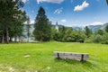 Bohinj church in the Ribcev Laz village, Slovenia. View of old ancient church from the park with bench. Slovenia alps with Triglav