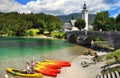 Bohinj Lake with boats and tourists, Church of St John the Baptist with bridge.Triglav National Park, Slovenia.